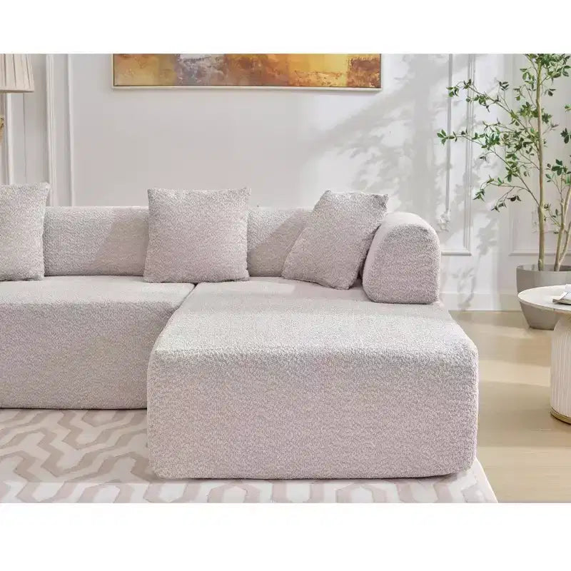 Divano componibile a L moderno da 355 cm con 4 posti, rivestimento in tessuto Boucle, 4 cuscini decorativi, nessun montaggio richiesto