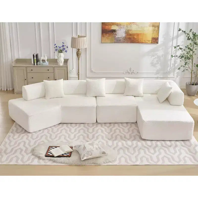 Divano componibile a L moderno da 355 cm con 4 posti, rivestimento in tessuto Boucle, 4 cuscini decorativi, nessun montaggio richiesto